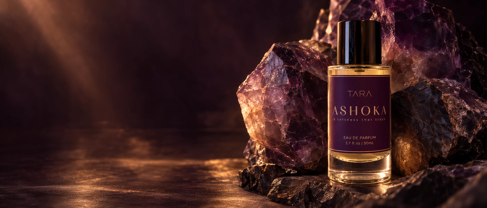 ASHOKA beside raw purple fluorite receiving low warm light